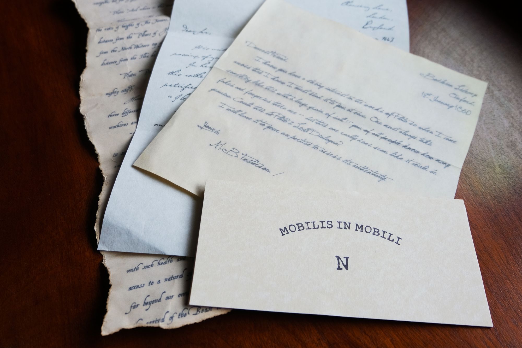 A pile of four letters, the front one reads 'Mobilis In Mobile - N'